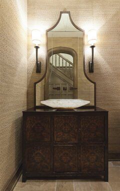 A bathroom with a mirror and a dresser.